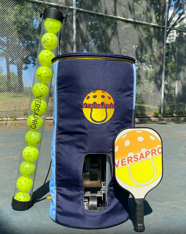 VersaPro ball machine on a pickleball court with ball tube and paddle
